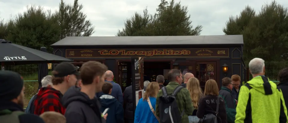 Crowd gathered around a My Little Pub build on a trade show ground